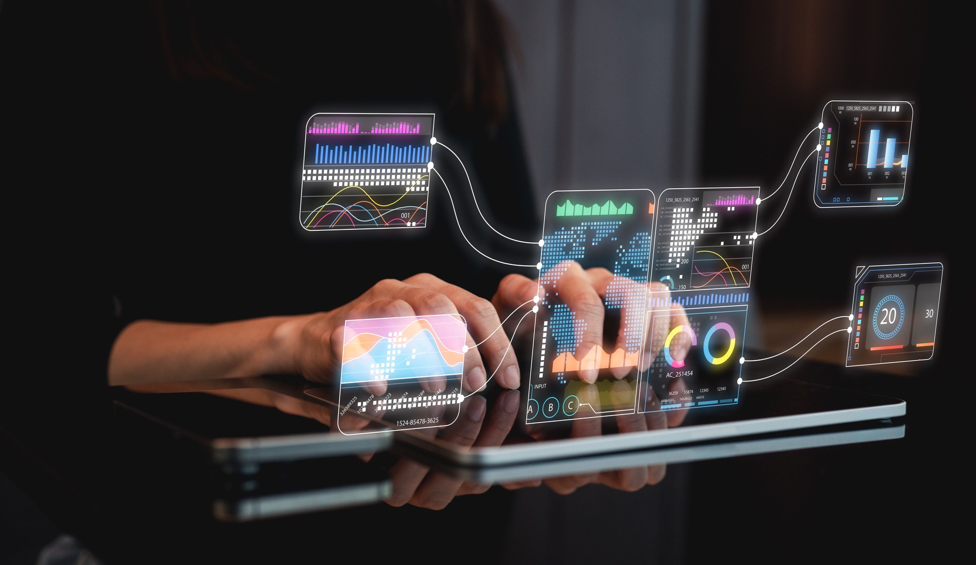 A person interacts with a high-tech digital interface displaying colorful data visualizations and analytics.